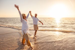 Active senior couple enjoying retirement outdoors thanks to independent living in Baldwin County, Alabama.