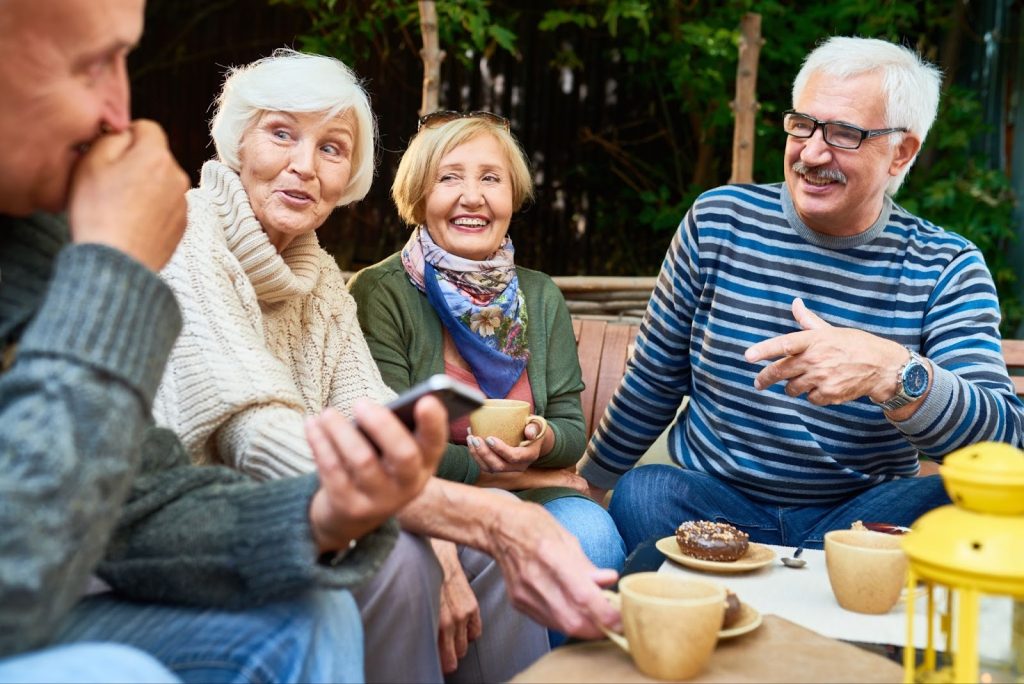 Friends enjoying dessert and coffee together, provided at an Independent Living Facility