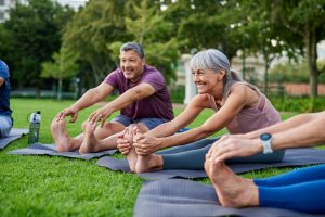 Active seniors participate in an outdoor yoga program as part of their independent living services