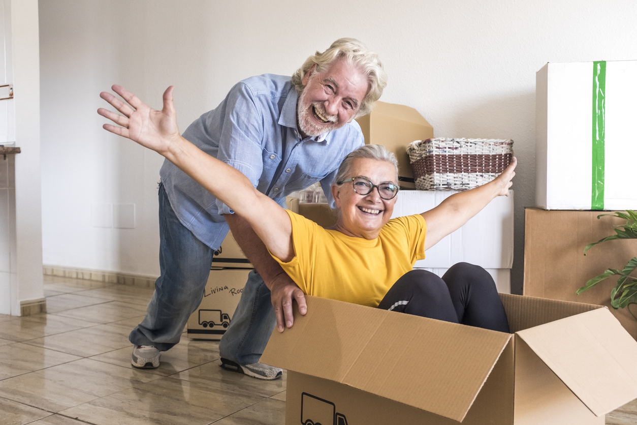 A husband and wife celebrate as they move into their independent living community.