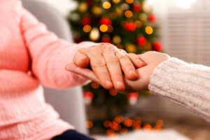 Senior and Caregiver Holding Hands Close Up_Community Senior Life