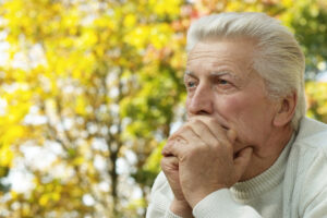 Senior Man Resting Chin in Hands_Community Senior Life