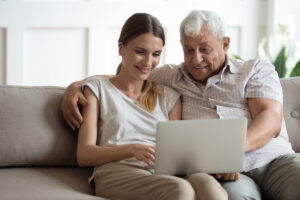 CSL_Senior Man and Adult Daughter Looking at Laptop